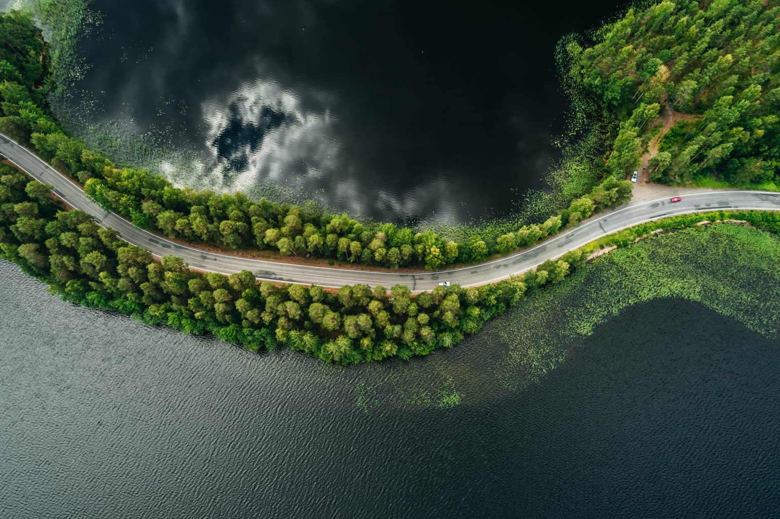 Road on a narrow piece of land between two lakes seen from the air at Punkaharju ridge Finland